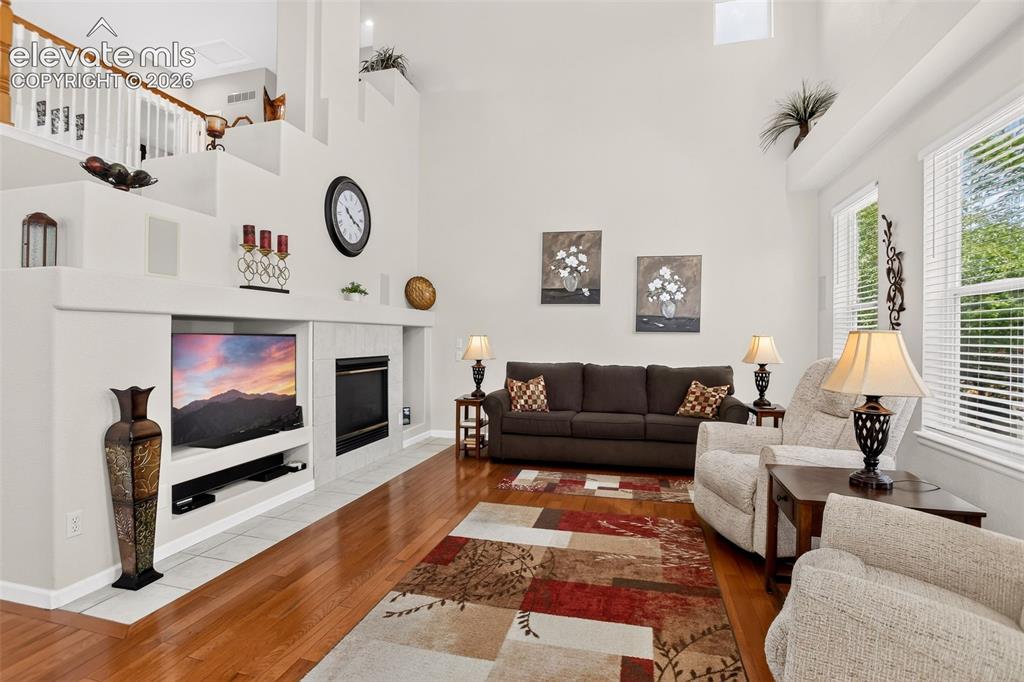 Image 14 of 42: Integrated entertainment center with fireplace, hardwood flooring, large wi