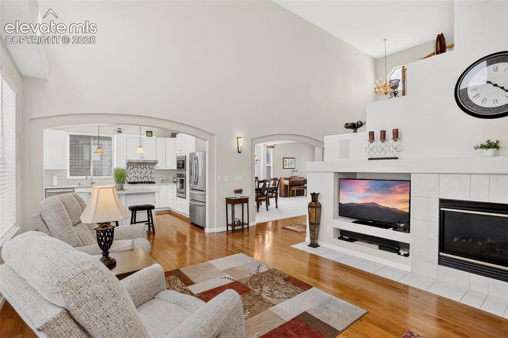 Image 16 of 42: Vaulted ceilings with warm wood-finish flooring