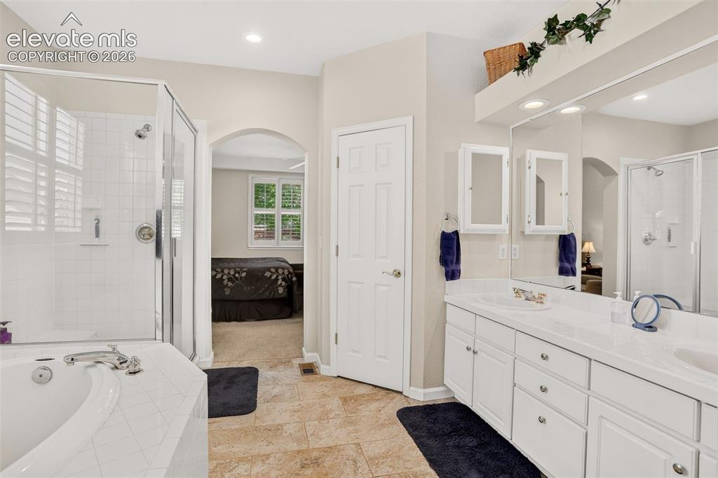 Image 22 of 42: Dual vanity with integrated sinks, framed mirror, built-in medicine cabinet