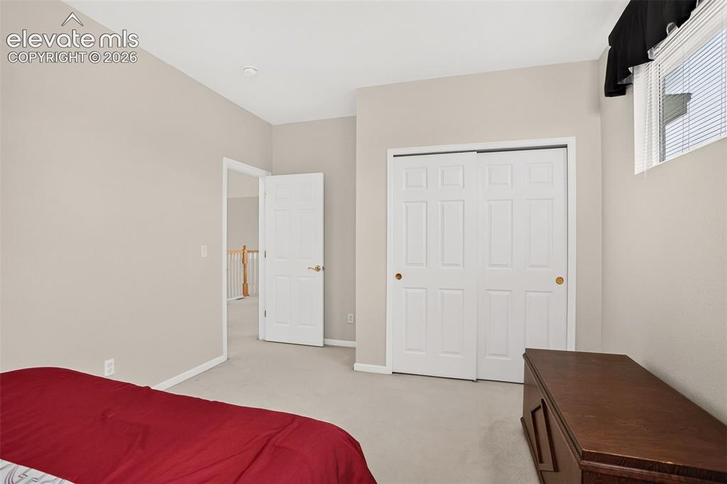 Image 30 of 42: Light-colored wall paint, white trim, carpeted flooring, window with blinds