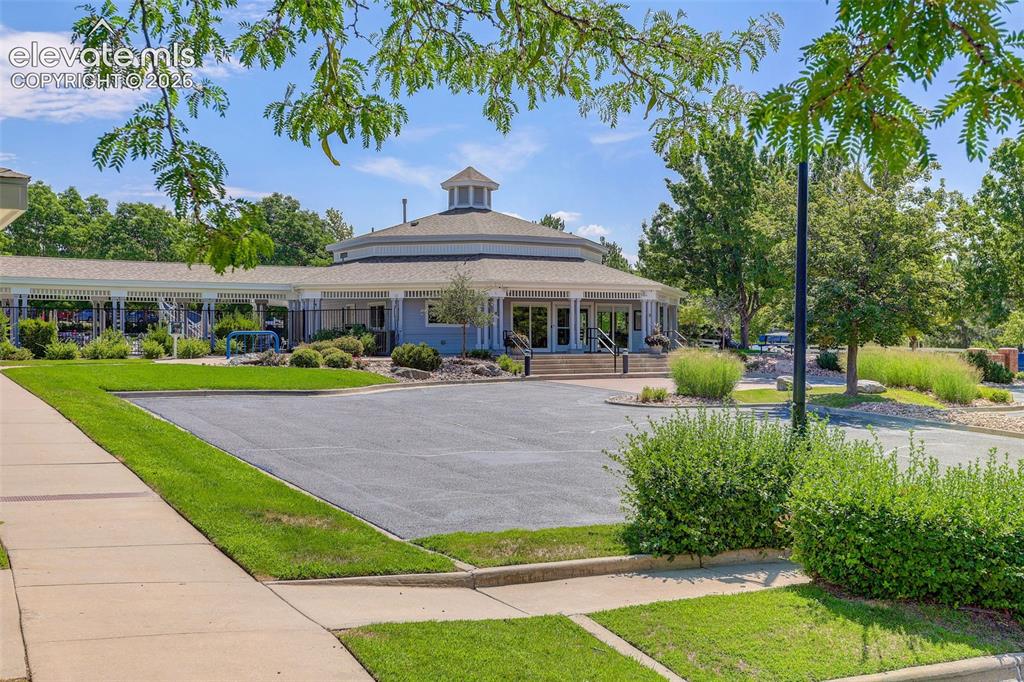 Image 41 of 42: Circular Clubhouse building with a cupola, surrounded by landscaped grounds