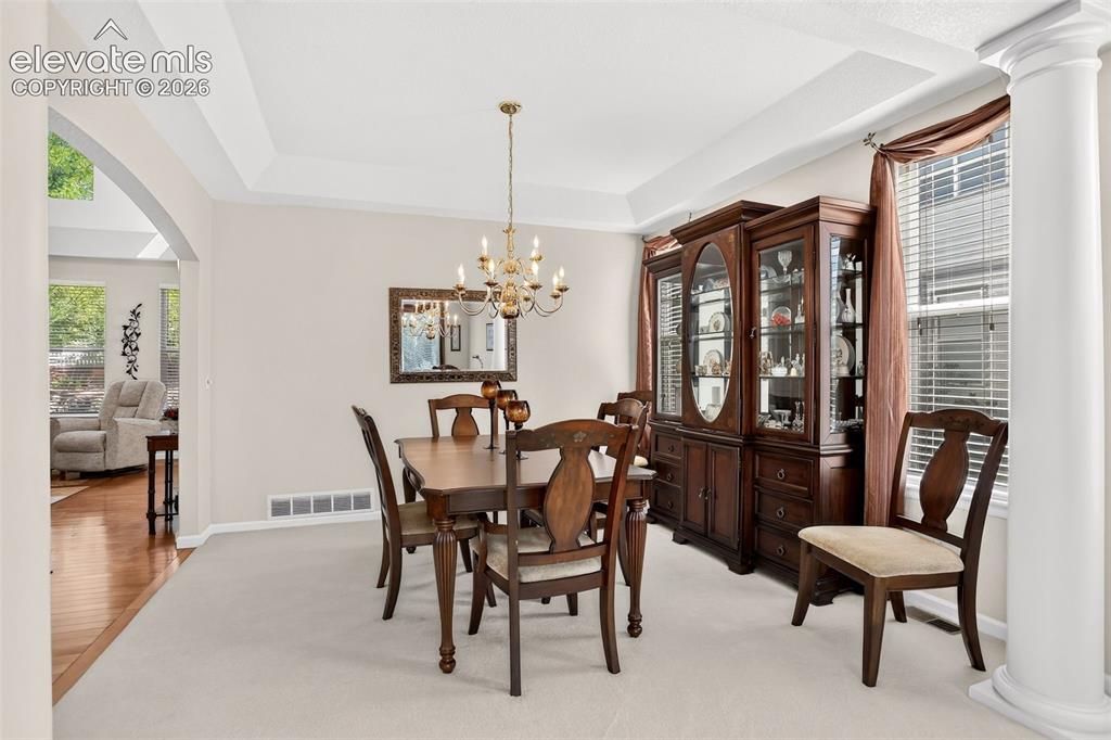 Image 7 of 42: Tray ceiling with a decorative chandelier