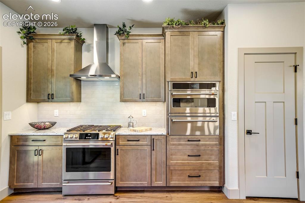 Image 13 of 48: Lovely chandelier and window in Great Room, with Breakfast Bar easily acces