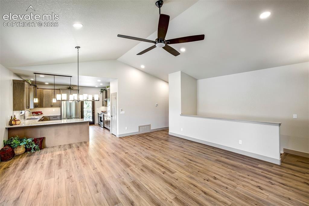 Image 5 of 48: Covered front porch is perfect to enjoy the outdoors, even when it rains.