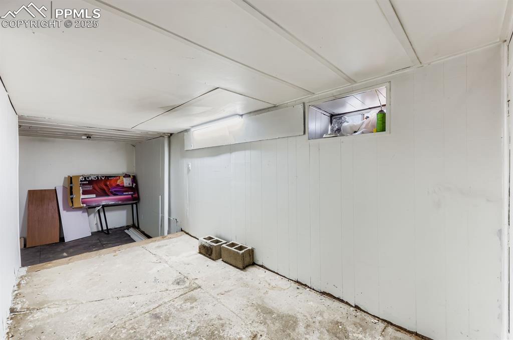 Image 8 of 10: Below grade area featuring wood walls