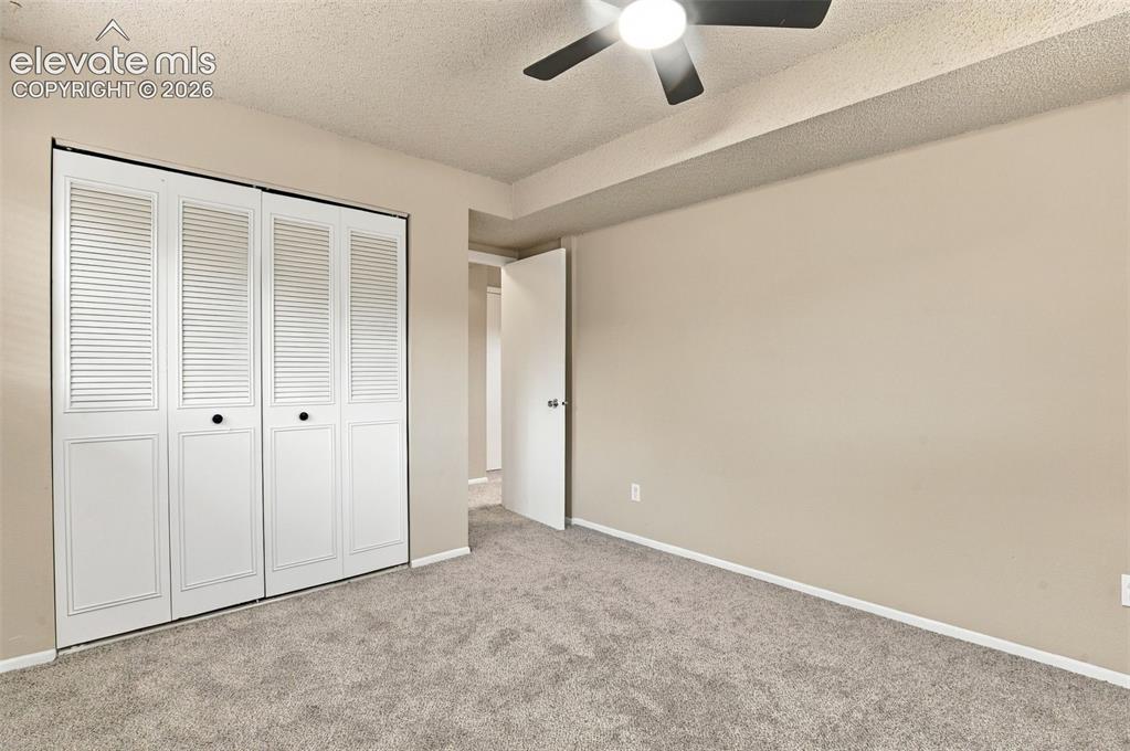 Image 26 of 50: Room featuring wall-to-wall carpeting, white bi-fold louvered closet doors,