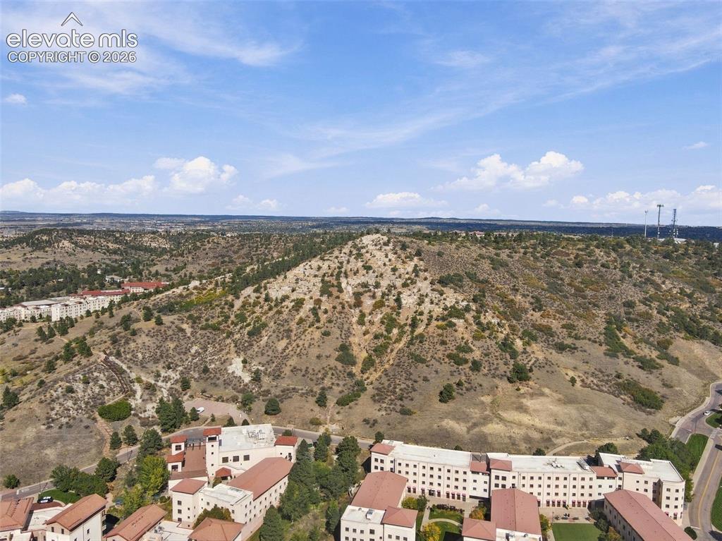 Image 37 of 50: Aerial perspective of a multi-building property complex featuring light-ton
