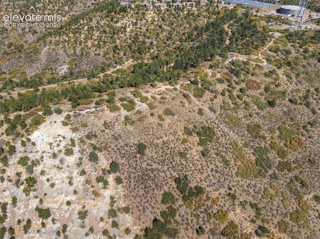 Image 38 of 50: Elevated hillside parcel featuring native vegetation, exposed rock outcropp