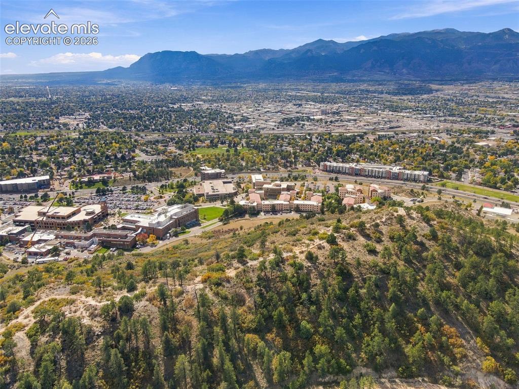 Image 40 of 50: Aerial perspective featuring prominent mountain range, native evergreen veg