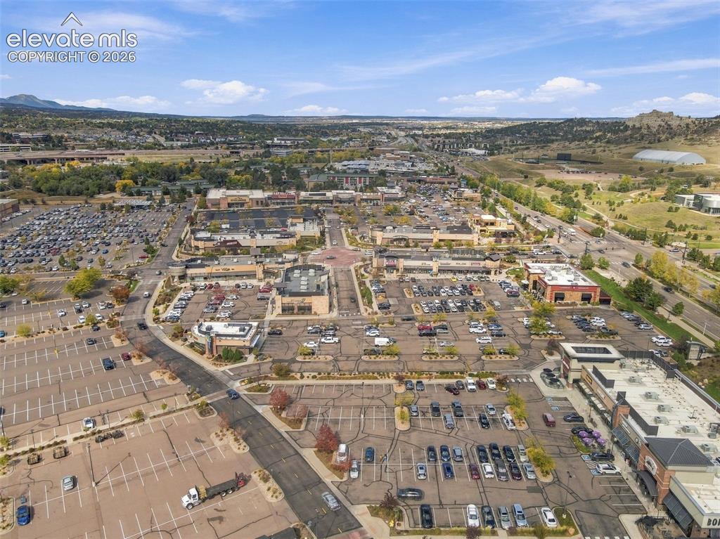 Image 44 of 50: Aerial perspective of a multi-building commercial plaza featuring extensive