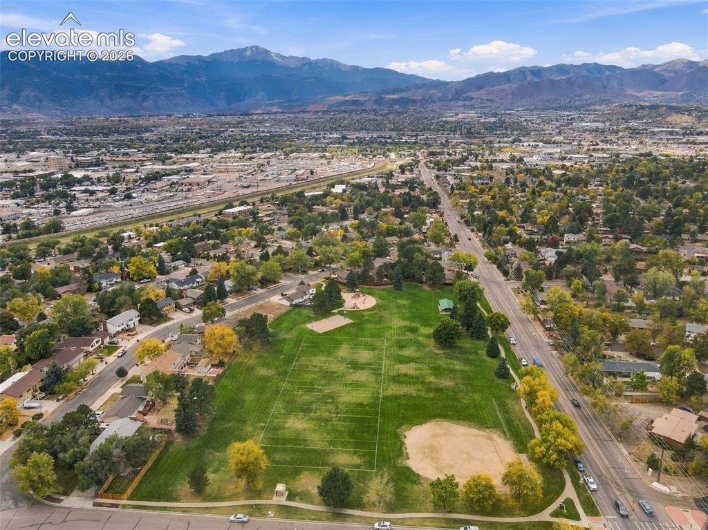 Image 46 of 50: Aerial perspective showcasing an expansive park area featuring open green s