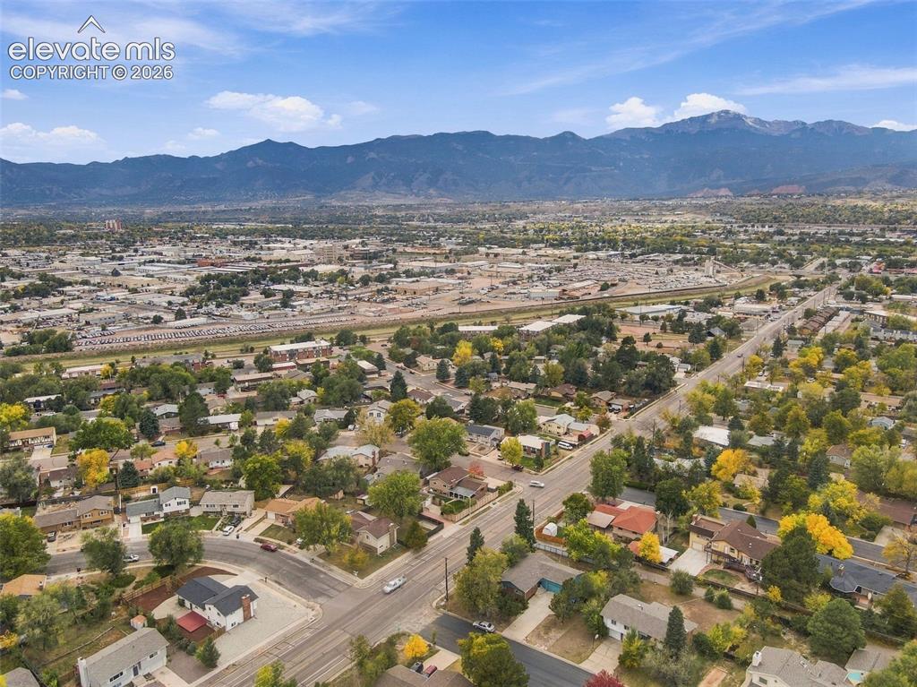 Image 47 of 50: Aerial perspective featuring mountainous horizon and expansive suburban lan