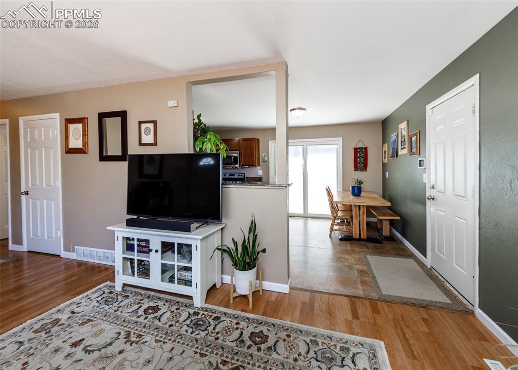 Image 12 of 39: Living area with light wood finished floors