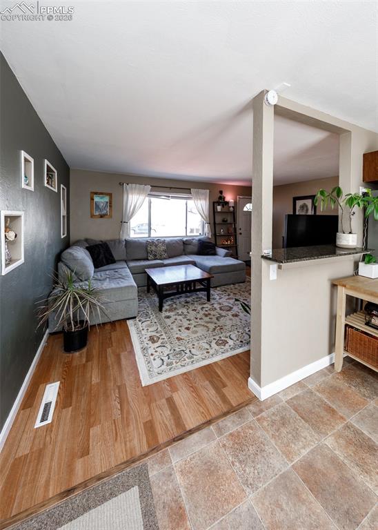 Image 13 of 39: Living room featuring baseboards and light wood finished floors