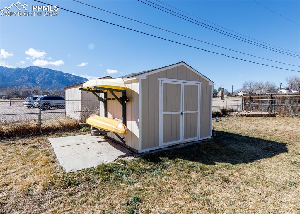 Image 21 of 39: View of shed with a fenced backyard and a mountain view