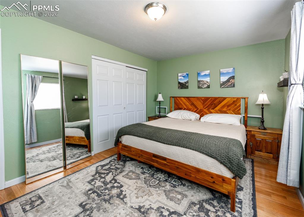 Image 28 of 39: Bedroom with light wood finished floors