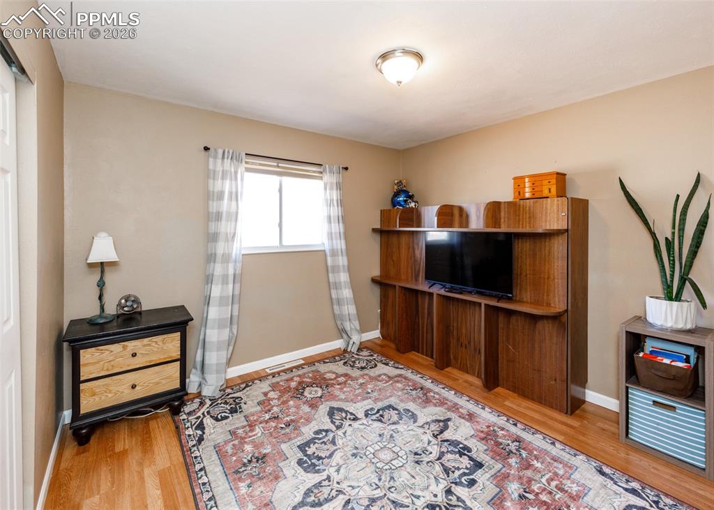 Image 30 of 39: Living area with light wood-type flooring