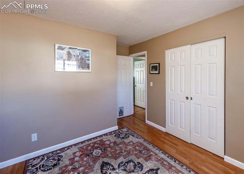 Image 31 of 39: Unfurnished bedroom with light wood finished floors and a closet