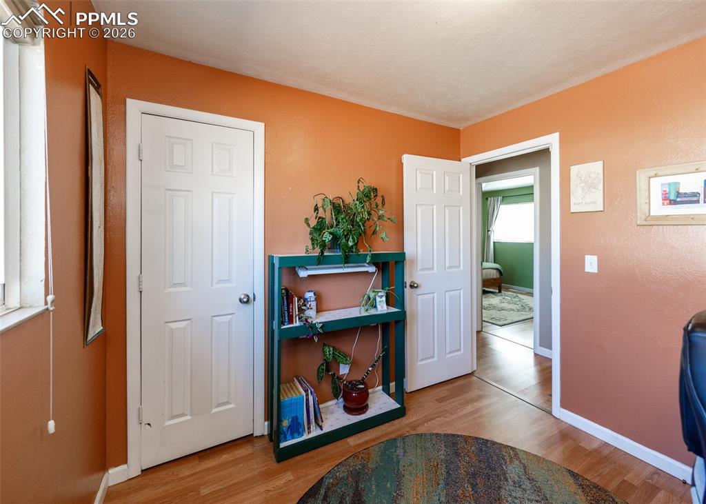 Image 34 of 39: Sitting room with light wood finished floors and baseboards