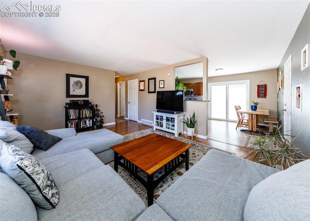 Image 9 of 39: Living area with wood finished floors and baseboards