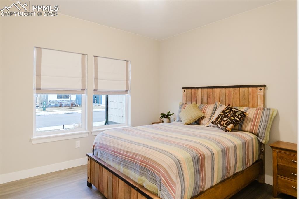 Image 15 of 31: The second main-floor bedroom is located in the front of the home. 