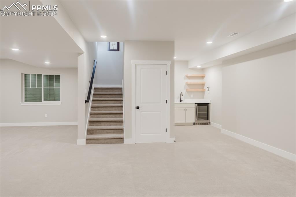 Image 21 of 31: View of the family room toward the bar area