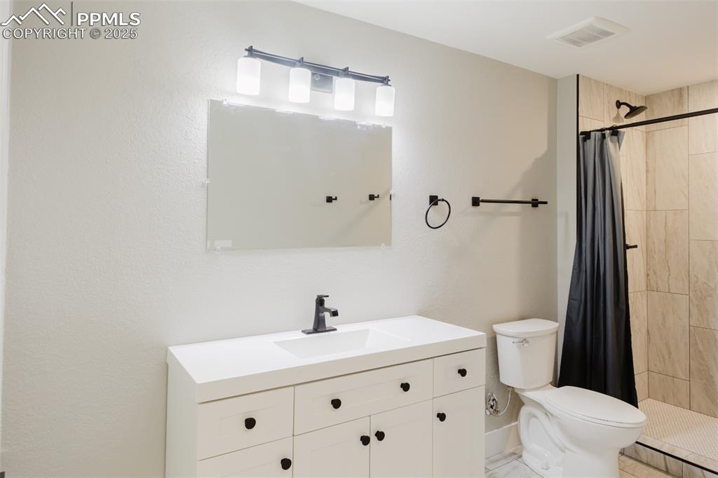 Image 23 of 31: This newly finished 3/4 bath is located on the basement level.