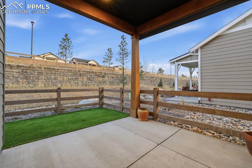 Image 38 of 45: The covered patio is the perfect spot for a morning cup of coffee.