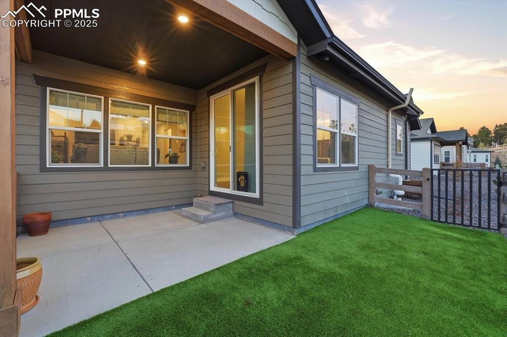 Image 39 of 45: The back yard has a fenced area and artificial turf.