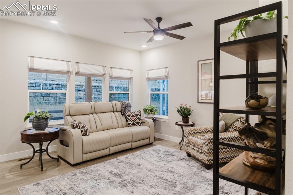 Image 5 of 31: The living room has plenty of windows for natural light and warmth from the