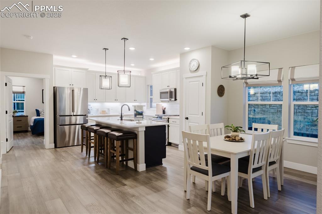 Image 9 of 31: The dining area is open to the kitchen and has a walk-out to the patio. 