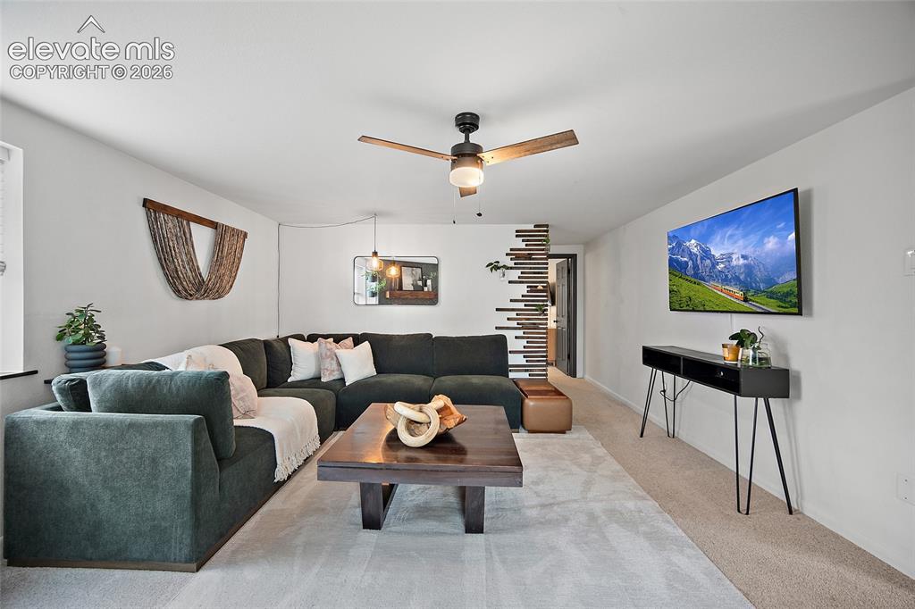 Image 17 of 43: Spacious living area featuring light-toned carpeting and white walls