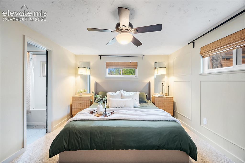 Image 23 of 43: Recessed lighting and a ceiling fan fixture illuminate this bedroom, featur