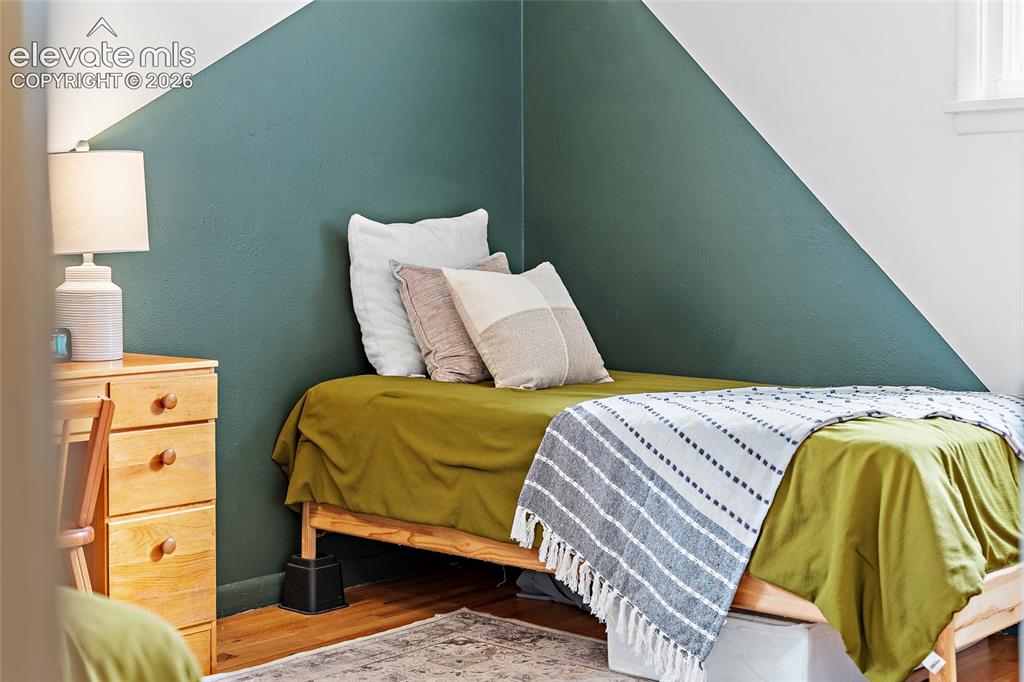 Image 34 of 43: Room featuring wood-finish flooring and a decorative area rug