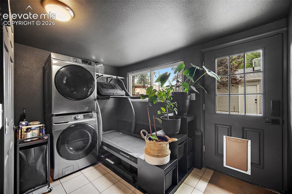 Image 36 of 43: Laundry area featuring tile flooring, a window, and a built-in shelf