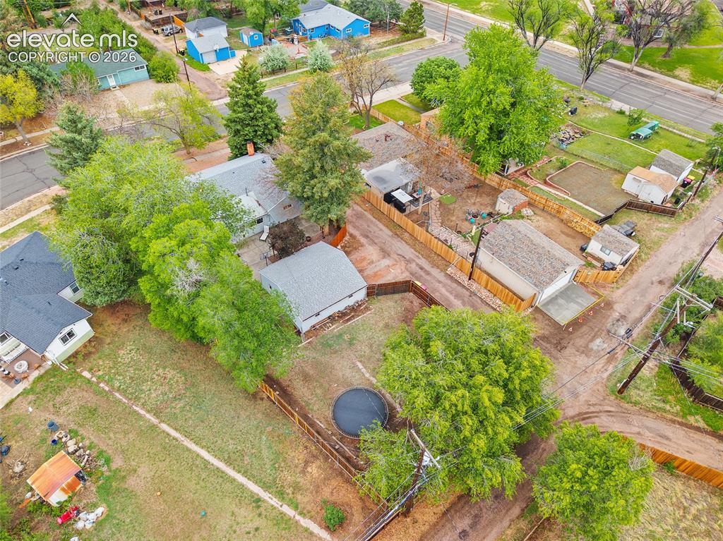 Image 42 of 43: Aerial view of the property featuring a detached garage, multiple outbuildi