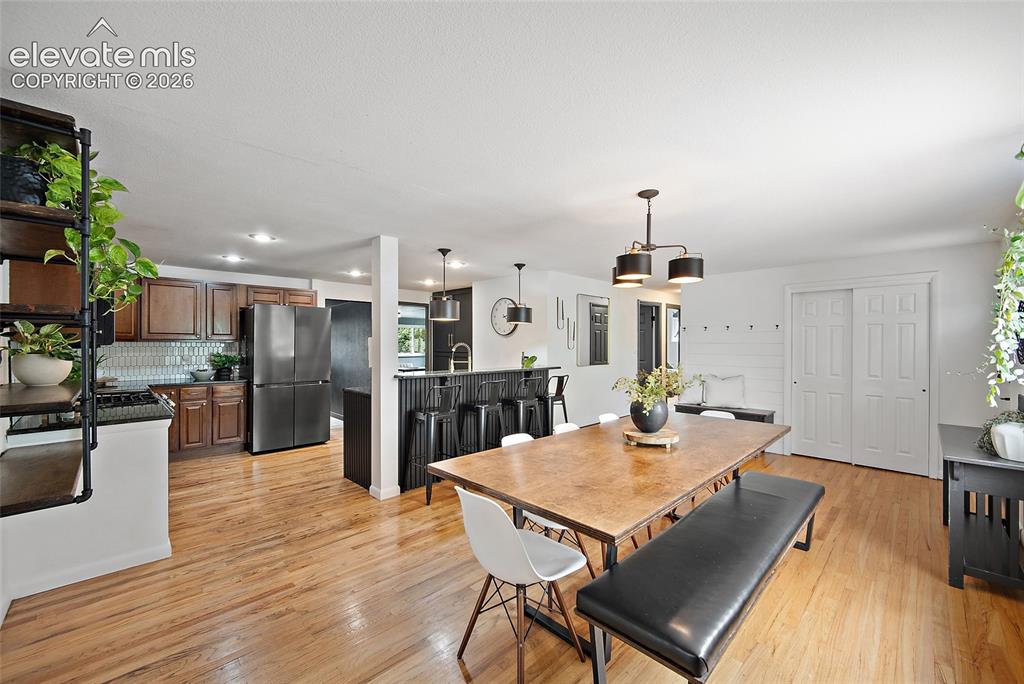 Image 5 of 43: Open-concept living space featuring wood-finish flooring throughout