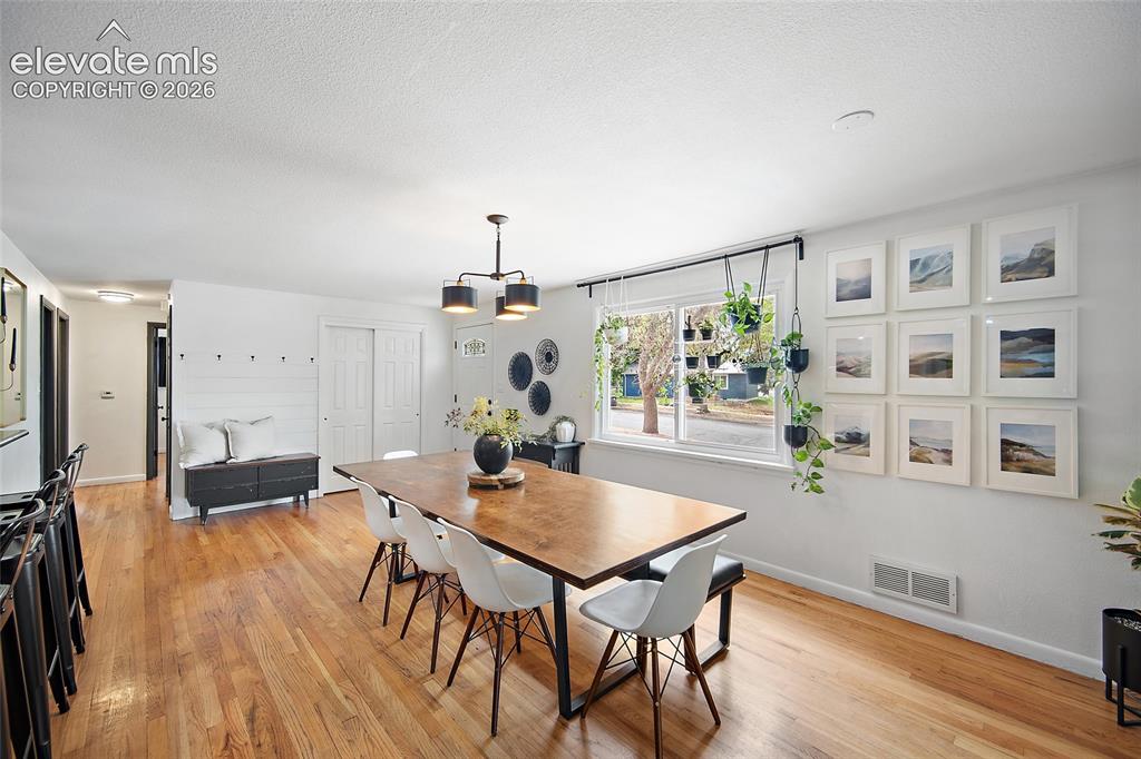 Image 6 of 43: Open-concept interior featuring wood-finish flooring, a large window, reces