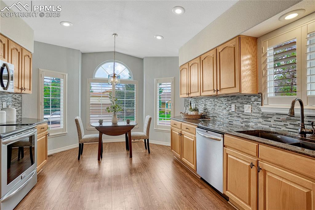 Image 10 of 38: Stainless steel appliances, plantation shutters and graphite sink.