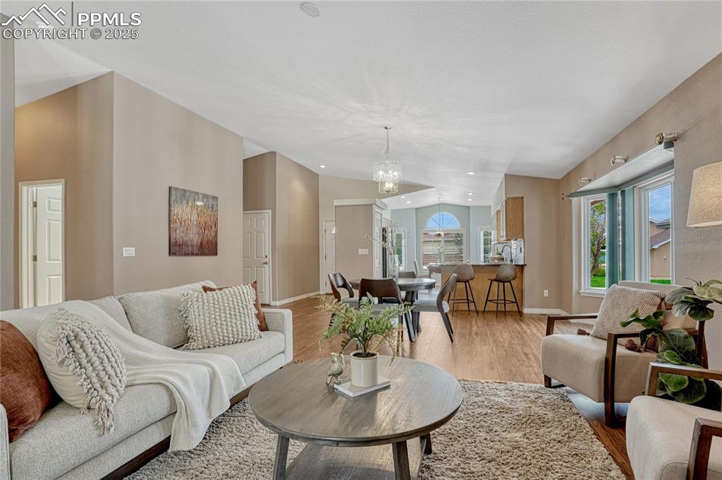 Image 7 of 38: Open concept floor plan with vaulted ceilings and luxury vinyl flooring.