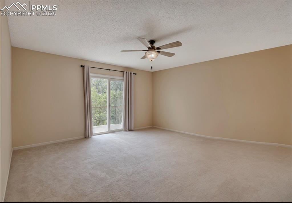 Image 16 of 41: Empty room featuring a textured ceiling, light carpet, and ceiling fan