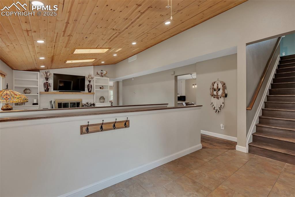Image 25 of 41: Kitchen featuring recessed lighting, wood ceiling, vaulted ceiling, light t