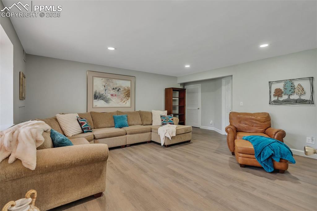 Image 26 of 41: Living room featuring recessed lighting and light wood finished floors