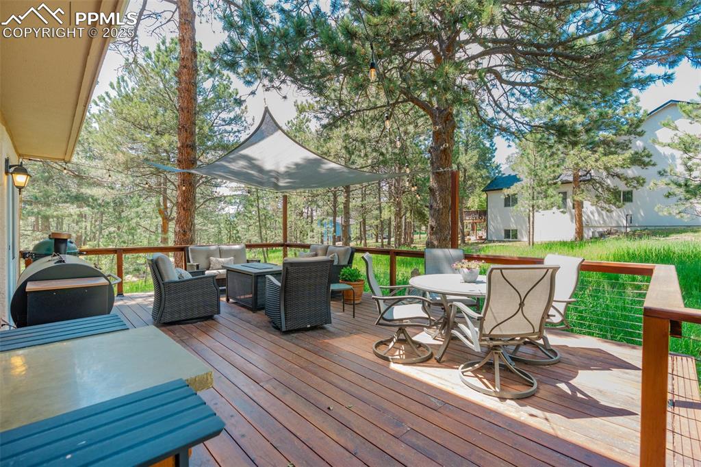 Image 35 of 41: Wooden terrace featuring outdoor lounge area and outdoor dining area