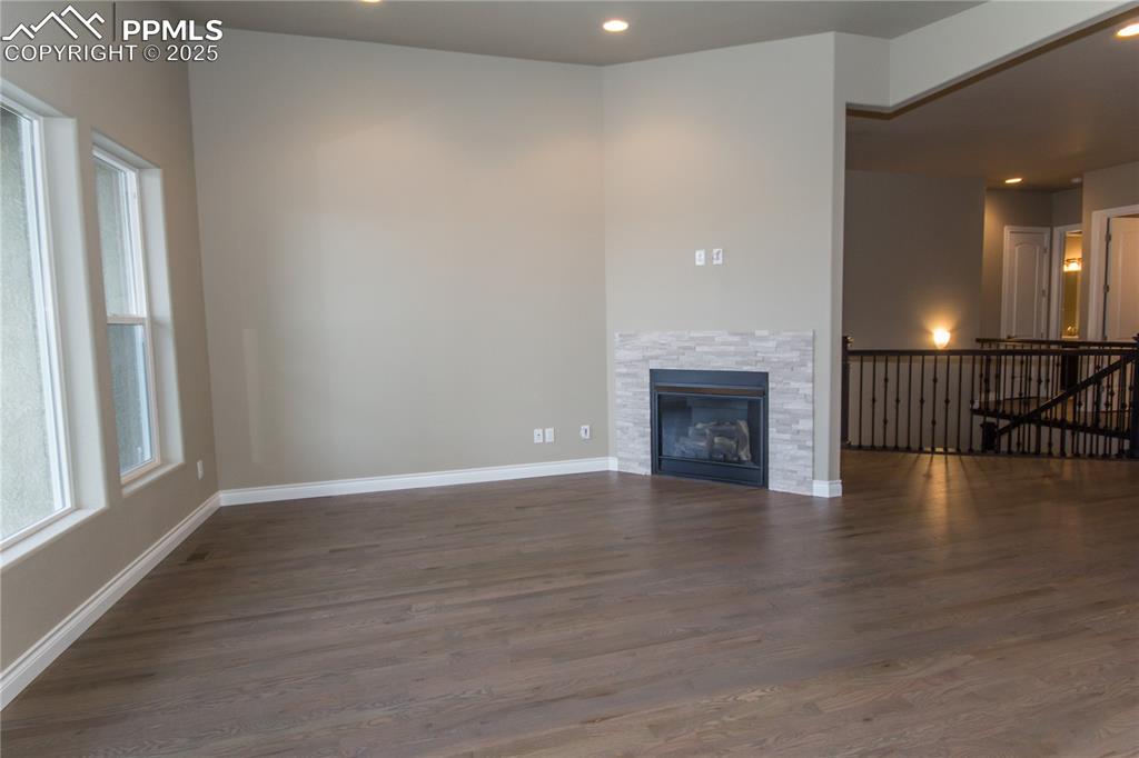 Image 13 of 28: Unfurnished living room featuring recessed lighting, dark wood finished flo