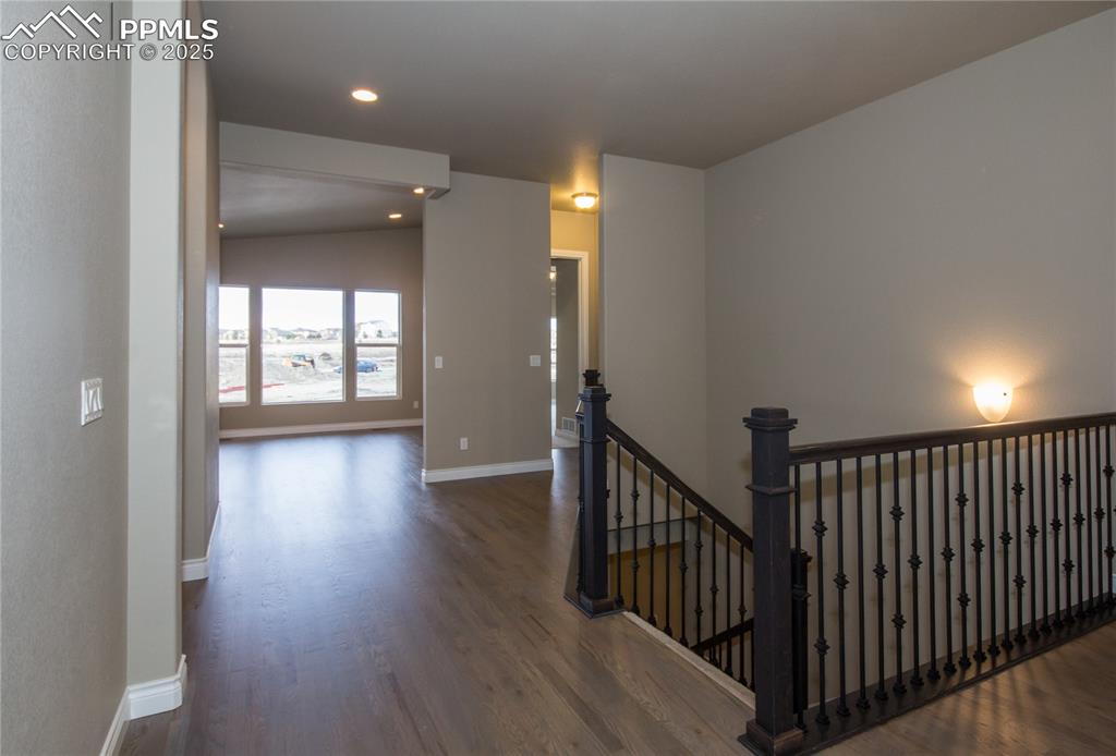 Image 2 of 28: Stairway featuring baseboards, wood finished floors, and recessed lighting