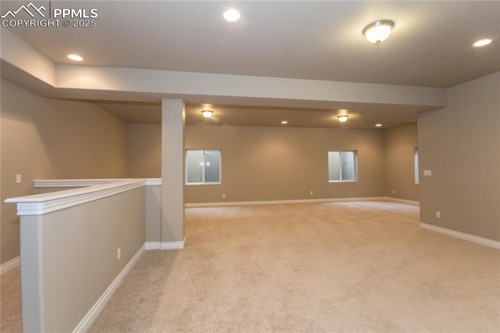 Image 23 of 28: Basement featuring recessed lighting, baseboards, and light colored carpet