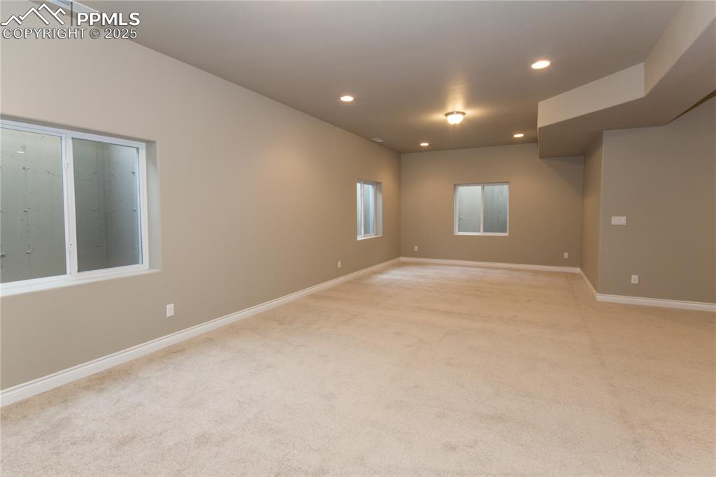 Image 25 of 28: Empty room with recessed lighting, baseboards, and light carpet