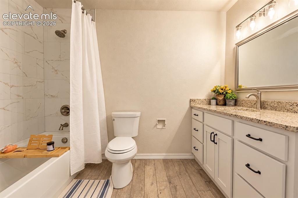 Image 17 of 30: White vanity with black pulls, granite countertop, brushed nickel faucet, l