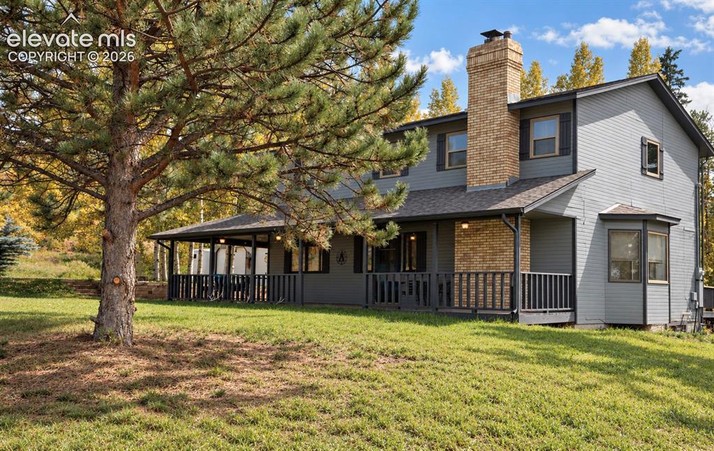 Image 20 of 30: Charming two-story colonial with brick and board-and-batten siding, featuri